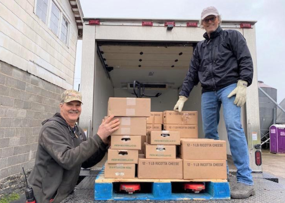 Rob Fulper and Jay Quilty load boxes of cheese and yogurt onto a truck