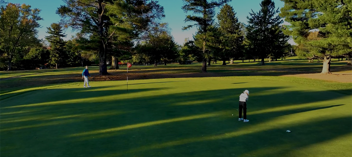 Two people on a putting green